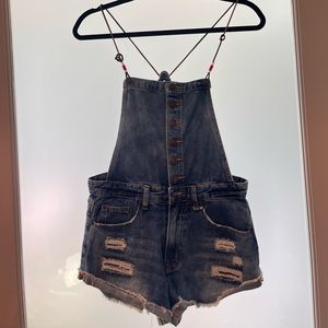 Dark distressed denim overalls